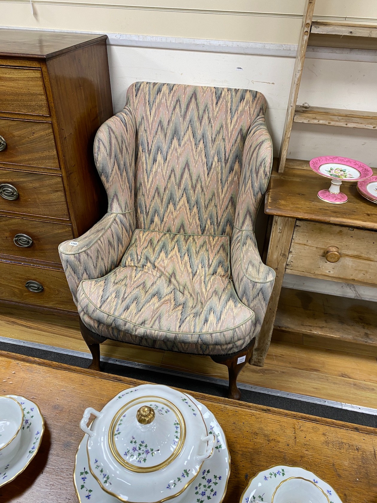 A George III style upholstered wing armchair, width 84cm, depth 75cm, height 112cm